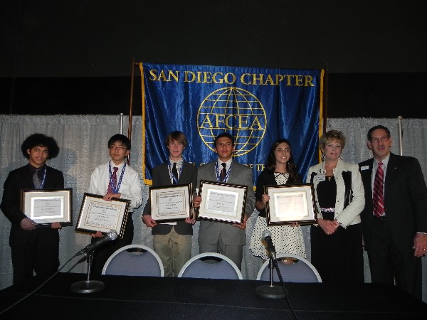 In April, Pat Kelly (r), chapter vice president for education, and Shirley Adams (2nd from r), chapter vice president for programs, hand out scholarship awards to this year's recipients.